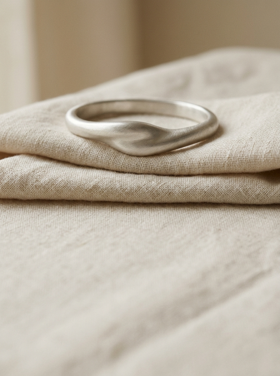 Aevum silver, an heirloom kada resting on folded linen.